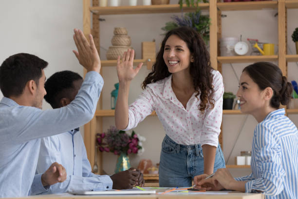 Happy excited two employees giving high five, celebrating team success Happy excited two employees giving high five, celebrating team success, work achieve, sales result, thanking for successful idea, completing project, enjoying teamwork together office buddies stock pictures, royalty-free photos & images