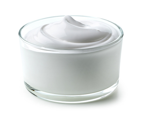 glass bowl of whipped egg whites cream isolated on white background