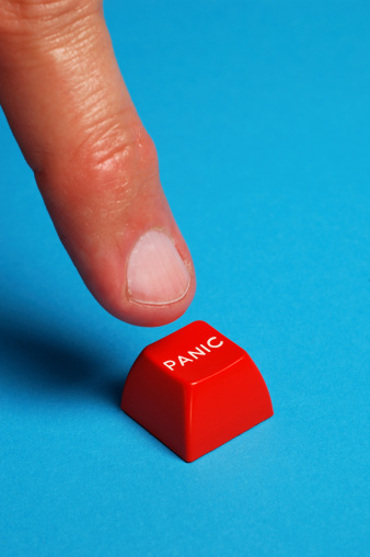 finger pushing red panic button