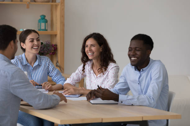 istock Cheerful excited diverse business team brainstorming at meeting table 1399628864