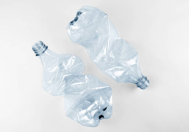 istock Two crumpled plastic water bottles on grey background 1399628926