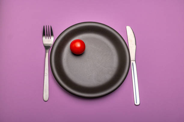 Online ordering a tomato in a plate, on a tablet screen. Digital power technology. Personal serving.