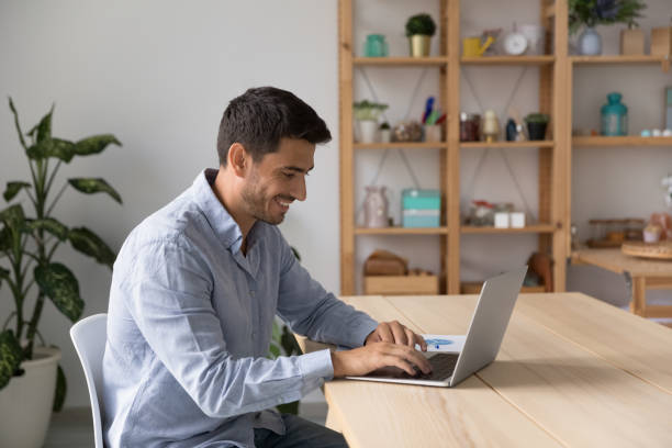 istock Happy millennial freelance employee man working at laptop 1399628970
