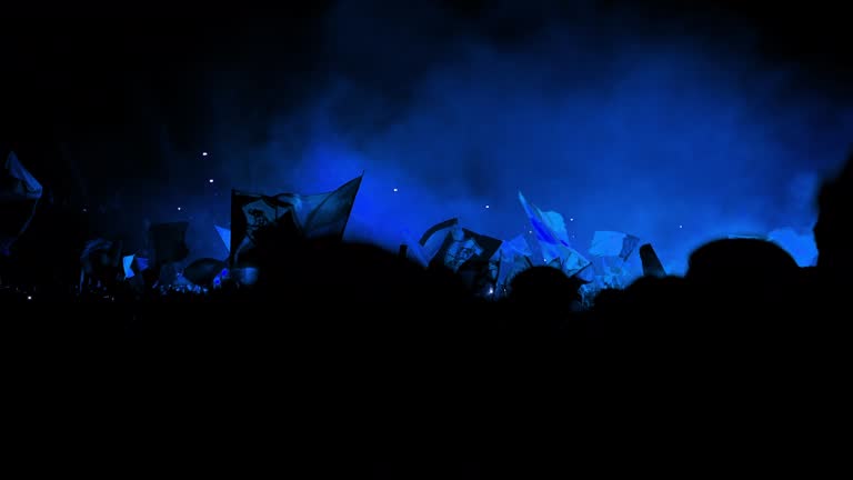 Football supporters with flags, flares and smoke bombs