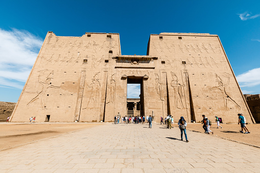 Edfu, Egypt - 11-5-2019: Group of tourists exploring the Temple of Horus in Edfu, Egypt.