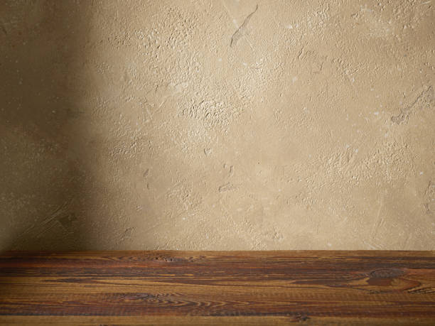 istock beige color wall and wooden table 1399630997