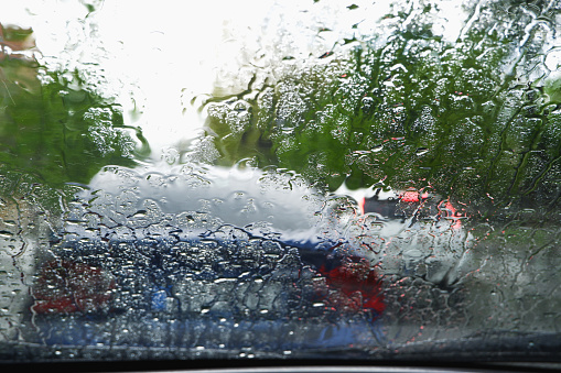 Driving a car in bad weather. Driving in a car in heavy rain. Difficult visibility from a car through a wet windshield