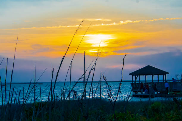 istock Sunset over water and gazebo 1399633520