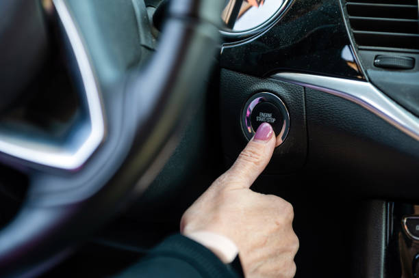 istock Woman hand pushing on car engine start-stop button. Modern car interior, closeup 1399634997