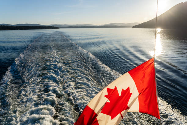 istock Ferry sailing on the ocean. Canadian flag and waves. 1399635008
