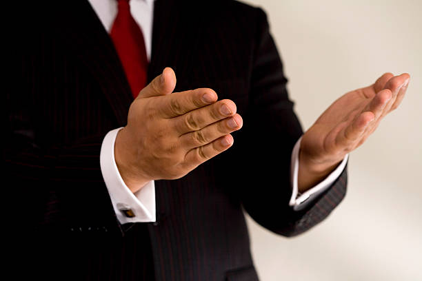 Businessman with both hands in open gesture stock photo