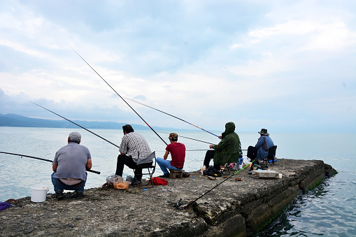 Sukhumi - June 16, 2017: Fishermans at the Black sea shore