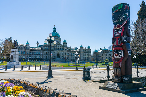 Victoria, BC, Canada - April 14 2021 : Kwakiutl Bear Pole Totum Pole. British Columbia Parliament Buildings.