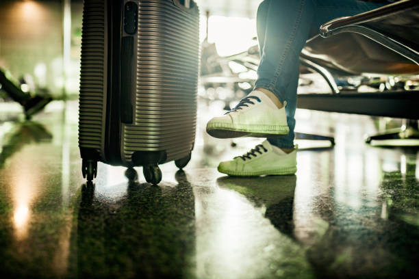istock Unrecognizable person with suitcase at departure area. 1399637682