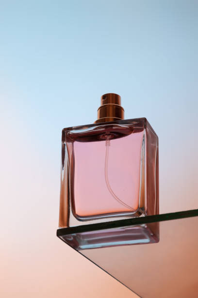 Bottom view of one spray bottle of perfume stands on a glass table Bottom view of one spray bottle of perfume stands on a glass table. perfume sprayer stock pictures, royalty-free photos & images