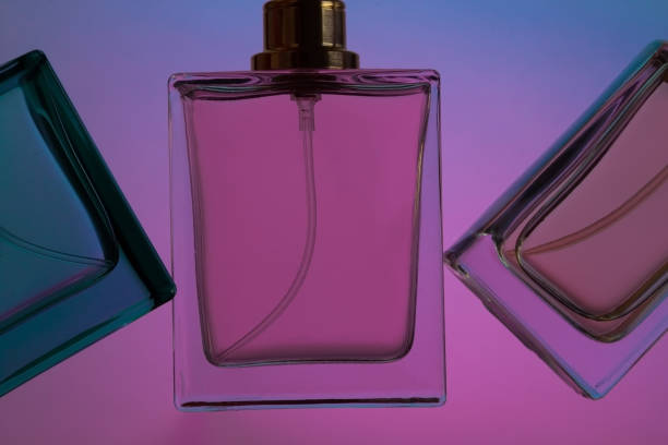 istock Set of perfume bottles on purple background. 1399637811