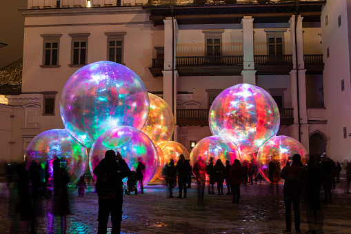 Vilnius, Lithuania - January 26, 2022: Light installation at the Palace of Grand Dukes with inflated bubbles illuminated by various colors during Vilnius Light Festival.
