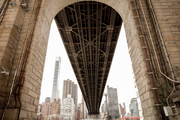 low angle view of queensboro bridge at new york city - queensborough bridge imagens e fotografias de stock