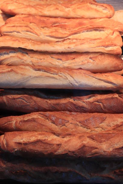 Typical French bread at a big bakery. Traditional french baguettes.