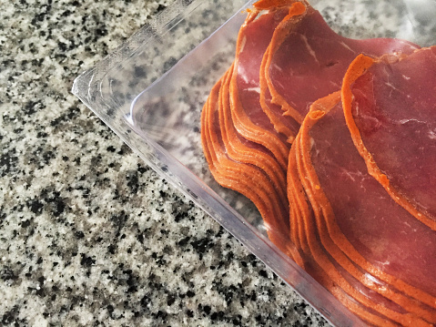 Turkish bacon pastrami, sliced pastrami in a plastic transparent package (Turkish Pastirma)
