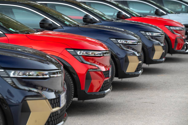 Marbella, Spain - February 4th, 2022: Electric crossover cars Renault Megane E-Tech parked on a public parking before the customers test drives.  This model is the first mass-produced electric compact car from Renault. Focus on a second car.