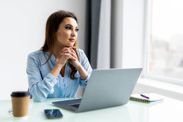 istock Business woman using laptop computer and sitting by the table in office 1399646421