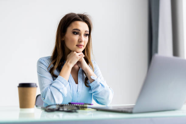 istock Business woman using laptop and sitting by the table in office 1399647595