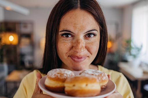 Closeup of woman eating doughnuts