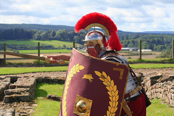 Take the Point Roman Soldier thrusts forward with Sword at ruins of an Acient Roman Fort in Northumberland, England. please see other Roman Soldiers from my Porfolio /file_thumbview_approve.php?size=1&id=2077653   roman centurion stock pictures, royalty-free photos & images