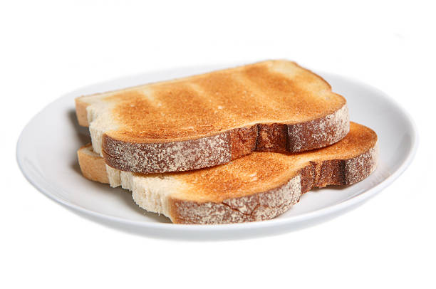 Two pieces of toasted white bread on a white plate stock photo