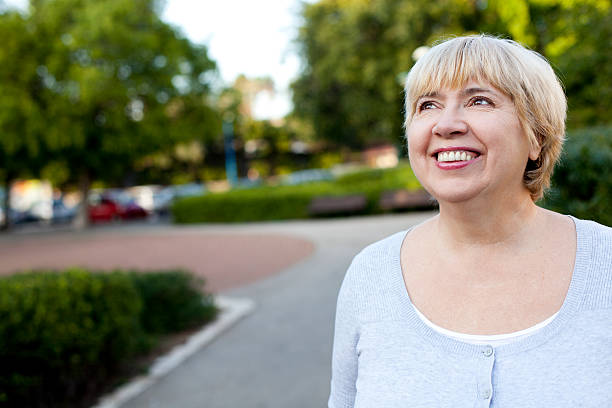 happy senior woman 屋外 - candid women portrait human face ストックフォトと画像