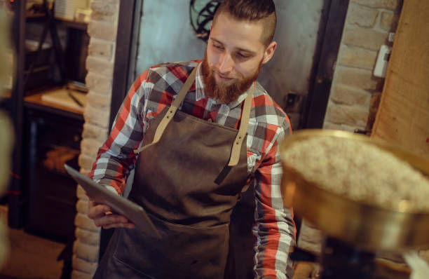 istock A young waiter writes on a digital tablet what to order from the goods. 1399655611