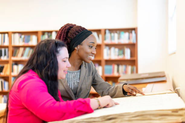istock Two diverse female professionals working and talking at work in an office 1399657044