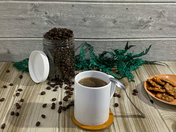 istock black coffee and black coffee beans on wooden table 1399658674