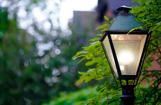 Old fashioned street lamp during rain in the dark