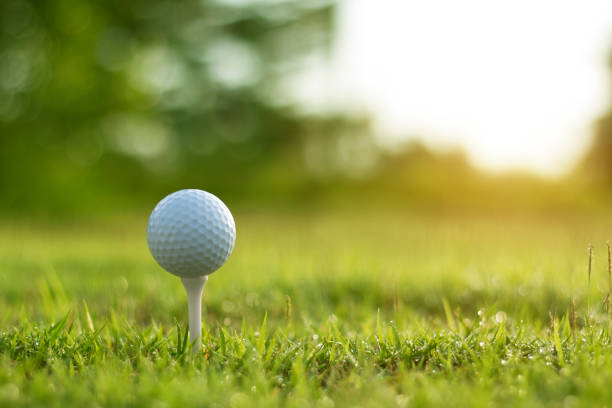istock golf ball on tee in a beautiful golf course with morning sunshine 1399659892