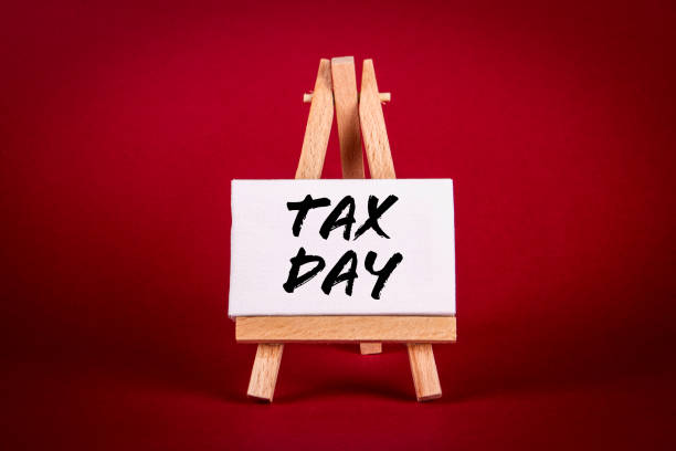 istock Tax Day. Miniature easel on a bright red background 1399660042