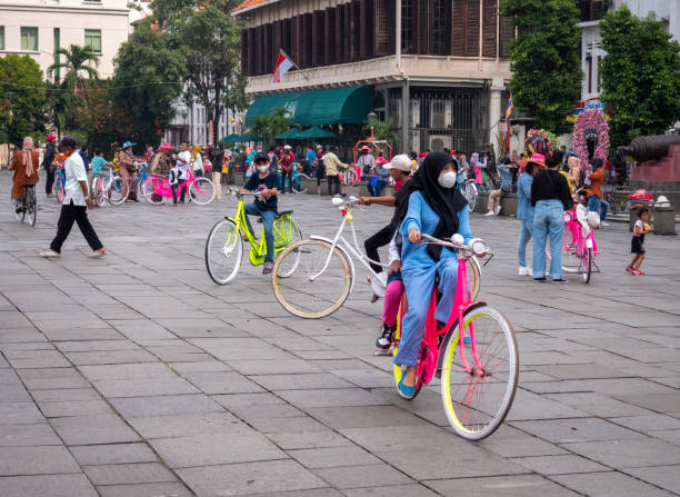 Jakarta, Indonesia - May 15, 2022: Crowds of people playing bicycles around Fatahillah Museum. Old Town, Jakarta, Indonesia.
