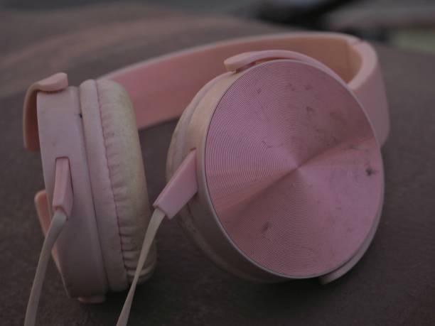 istock Pink headphones and brown background 1399669501