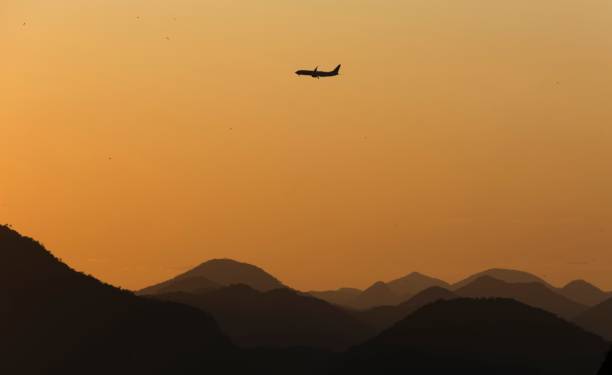istock Jet plane flying over the mountains at sunrise. 1399674013