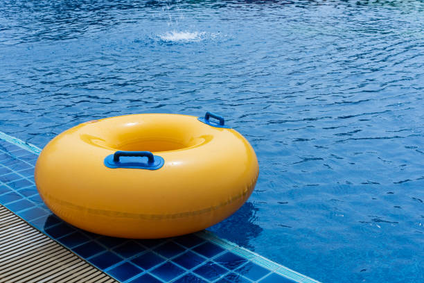 istock Yellow floating ring in swimming pool. Rubber ring swimming. Summer concept. 1399675560