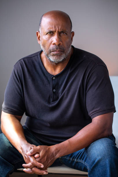 mature african american man with a serious look on his face. - portrait men senior adult depression imagens e fotografias de stock