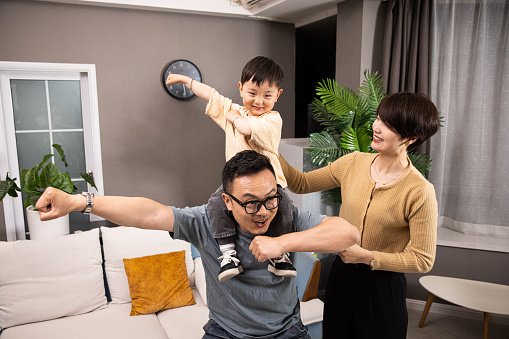 Asian family playing at home