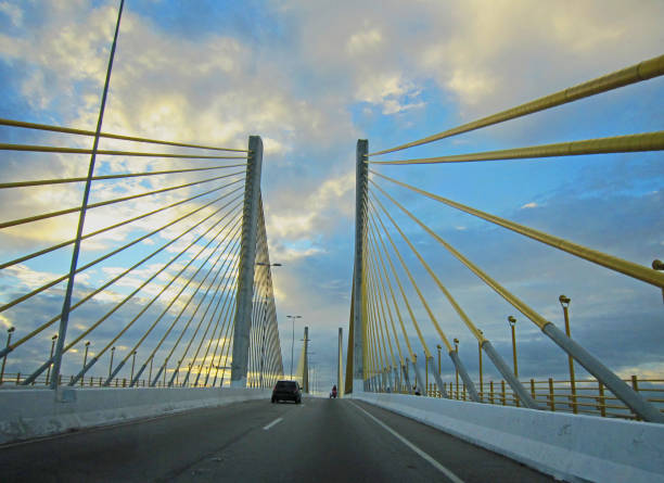 Ponte Newton Navarro.  Newton Navarro Bridge.   View of towers and suspension.   View from road.  Cloudy, blue skies.  Rio Grande do Norte, Brazil (Brasil).  Natal.