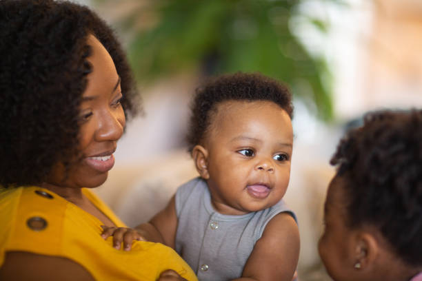 istock Happy mother smiling and playing with her son at home. 1399678269