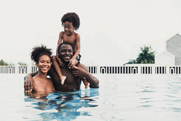istock Father, mother and their son in pool, enjoying their break. 1399680391