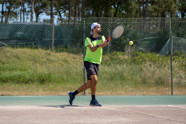 istock Tennis player hitting backhand at ball 1399681411