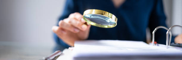 istock Businesswoman Checking Bill Through Magnifying Glass 1399683138