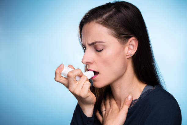 istock Woman With Asthma Using An Asthma Inhaler 1399683197