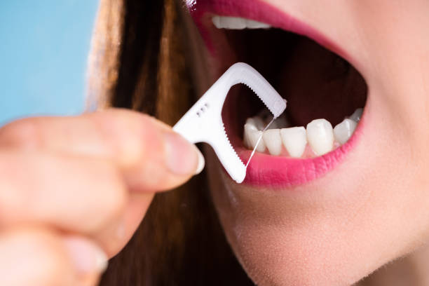 istock Woman Cleaning Teeth With Dental Floss 1399683207